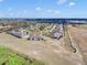 Expansive aerial view of a low-rise home community with walking path adjacent to a preserved natural area at 3640 Solana Cir # A, Clermont, FL 34711