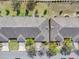 Aerial view of townhomes showcasing roof lines, driveways, landscaping, and nearby street at 3640 Solana Cir # A, Clermont, FL 34711