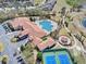 A bird's eye view of the community's sparkling pool, tennis courts, and clubhouse at 3640 Solana Cir # A, Clermont, FL 34711