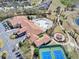 An aerial of the community clubhouse featuring a pool and tennis courts at 3640 Solana Cir # A, Clermont, FL 34711