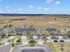 Aerial view of well-maintained homes with lush landscaping in a vibrant community surrounded by open fields at 3640 Solana Cir # A, Clermont, FL 34711