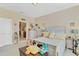 Bright bedroom with neutral paint, a comfortable bed, and a view to an adjacent room at 3640 Solana Cir # A, Clermont, FL 34711