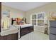 Well-lit bedroom with a large window and neutral-colored walls at 3640 Solana Cir # A, Clermont, FL 34711