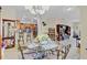 Inviting dining area with a glass-topped table, view of the kitchen, and hardwood floors at 3640 Solana Cir # A, Clermont, FL 34711