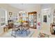 Bright dining room with a glass table, chandelier, and a decorative china cabinet, creating an elegant eating space at 3640 Solana Cir # A, Clermont, FL 34711