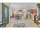 Open-concept dining room with a glass table and ornate chairs, seamlessly connected to the kitchen at 3640 Solana Cir # A, Clermont, FL 34711