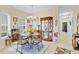 Bright dining room featuring a chandelier, display cabinet, and views into the hallway at 3640 Solana Cir # A, Clermont, FL 34711