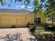 Inviting single-story home with a two-car garage and a brick driveway lined with lush landscaping at 3640 Solana Cir # A, Clermont, FL 34711