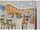 Well-lit kitchen with granite countertops, stainless steel appliances, and ample cabinet space at 3640 Solana Cir # A, Clermont, FL 34711