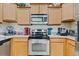 Kitchen close up with stainless steel oven, microwave, and granite countertops at 3640 Solana Cir # A, Clermont, FL 34711