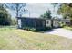 Charming home featuring a screened porch, white picket fence, and inviting curb appeal at 3708 Merryweather Dr, Orlando, FL 32812