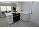 Well-lit kitchen with modern appliances, white cabinets, and a cooktop island, perfect for cooking and entertaining at 3708 Merryweather Dr, Orlando, FL 32812