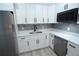 Close-up of a well-appointed kitchen with white cabinets, stainless steel appliances, and a stylish backsplash at 3708 Merryweather Dr, Orlando, FL 32812