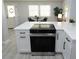 Modern kitchen island with a cooktop, white cabinets, stainless steel appliances, and space for casual dining at 3708 Merryweather Dr, Orlando, FL 32812