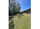 A backyard with a wooden fence and a tree at 3719 Madbury Cir, Lakeland, FL 33810