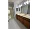 Bathroom featuring double sinks, light fixtures, a mirror, and tile flooring at 3719 Madbury Cir, Lakeland, FL 33810