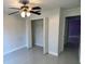 A bright bedroom with a ceiling fan and closet at 3719 Madbury Cir, Lakeland, FL 33810