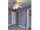 Bedroom with purple walls, ceiling fan, and tile flooring at 3719 Madbury Cir, Lakeland, FL 33810