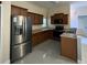 The kitchen features stainless steel appliances and wood cabinets at 3719 Madbury Cir, Lakeland, FL 33810