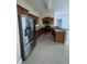 Spacious kitchen featuring stainless steel appliances, wooden cabinets, and light countertops at 3719 Madbury Cir, Lakeland, FL 33810