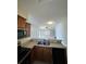 A kitchen featuring stainless steel appliances, and a breakfast bar looking into the living room at 3719 Madbury Cir, Lakeland, FL 33810