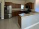 Spacious kitchen featuring stainless steel appliances, wooden cabinets, and light countertops at 3719 Madbury Cir, Lakeland, FL 33810