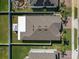 An aerial view of a home's roof, backyard and white fencing in a residential neighborhood at 3861 Hanworth Loop, Sanford, FL 32773