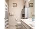 Bathroom featuring a gray and white tiled shower and neutral colored vanity at 3861 Hanworth Loop, Sanford, FL 32773