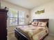 Cozy bedroom with a large window and warm, inviting decor at 3861 Hanworth Loop, Sanford, FL 32773