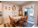 Dining area with natural light, casual decor, and access to the screened-in porch at 3861 Hanworth Loop, Sanford, FL 32773