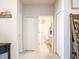 Bright hallway with white doors and tiled floor at 3861 Hanworth Loop, Sanford, FL 32773