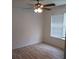 Bright bedroom featuring laminate floors, a ceiling fan, and large window at 4275 Perkinshire Ln # 204, Orlando, FL 32822