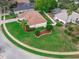 An aerial view shows the landscaping, brown roof, and fenced in backyard of the home at 460 Quail Hill Dr, Debary, FL 32713