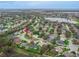 Overhead view of a residential area showcasing diverse housing styles, mature trees, and manicured lawns in a desirable location at 460 Quail Hill Dr, Debary, FL 32713