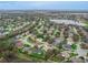 High aerial view of a suburban neighborhood with winding roads, green spaces, and a variety of well-kept homes at 460 Quail Hill Dr, Debary, FL 32713