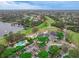 Stunning aerial view showcasing community pool, lakeside golf course and country club with expansive parking at 460 Quail Hill Dr, Debary, FL 32713