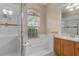 Well-lit bathroom with a tiled shower, separate tub, and a large window bringing in natural light at 460 Quail Hill Dr, Debary, FL 32713