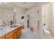 Bathroom with double sinks, large mirrors, and a view into the bedroom and toilet area at 460 Quail Hill Dr, Debary, FL 32713