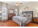 Comfortable bedroom with wood floors, dresser, and a window with curtains, creating a relaxing atmosphere at 460 Quail Hill Dr, Debary, FL 32713