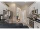 Modern kitchen featuring stainless steel appliances, white cabinets, and black countertops at 460 Quail Hill Dr, Debary, FL 32713