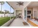 Enclosed patio with a lush green lawn, seating, and views into the bedroom and living room at 460 Quail Hill Dr, Debary, FL 32713