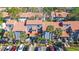 Aerial view of a community with a well maintained landscape, complex buildings, and parking at 4713 Capri Pl # 190, Orlando, FL 32811