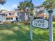 Capri Place sign surrounded by lush green lawn and mature landscaping on a bright sunny day at 4713 Capri Pl # 190, Orlando, FL 32811