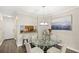 Inviting dining area features a glass table with seating for four, a stylish light fixture, and wood floors at 4713 Capri Pl # 190, Orlando, FL 32811