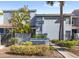 Charming townhome features lush landscaping, mature palm trees, and a walkway leading to the front entrance at 4713 Capri Pl # 190, Orlando, FL 32811