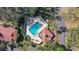 Aerial view of a community pool area with ample seating, a covered pavilion and a modern geometric pool design at 4713 Capri Pl # 190, Orlando, FL 32811