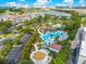 Stunning aerial view showcasing the community pool, lush landscaping, and nearby lake at 5000 Cayview Ave # 10108, Orlando, FL 32819