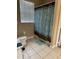 Bathroom featuring toilet, shower with curtain, tile floor, and towel rack at 5000 Cayview Ave # 10108, Orlando, FL 32819