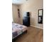 Bedroom with wood floors, dresser, mirror and quilt-covered bed at 5000 Cayview Ave # 10108, Orlando, FL 32819