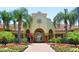 Community building with lush landscaping and a brick walkway leading to the entrance at 5000 Cayview Ave # 10108, Orlando, FL 32819